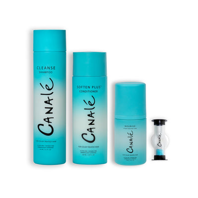 Bottles of Canale Cleanse Shampoo, Canale Soften Plus Conditioner and Canale Nourish Vitamin Enriching Foam lined up in a row next to a small sand timer branded with the Canale logo against a white background.